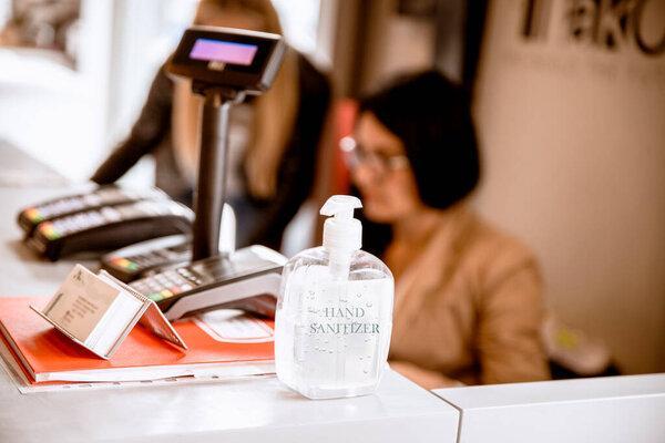 hand sanitizer on background of Female in office