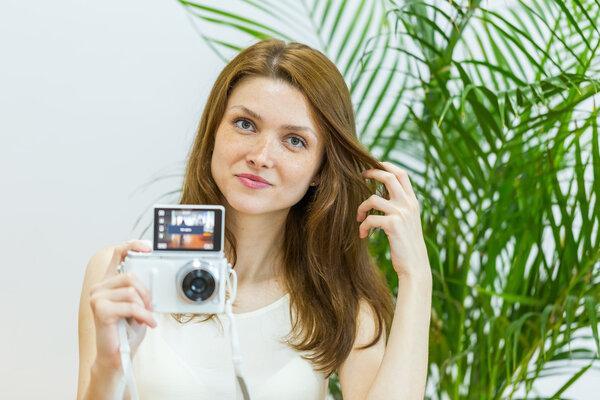 Happy young woman taking a selfie photo.