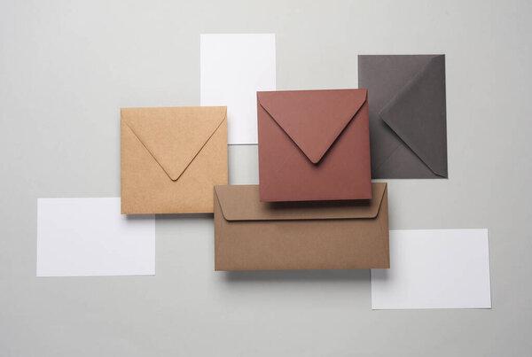 Floating envelopes and cards on gray background with shadow. Minimalism, modern business still life, creative layout