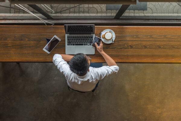 Top view of businessman using smartphone