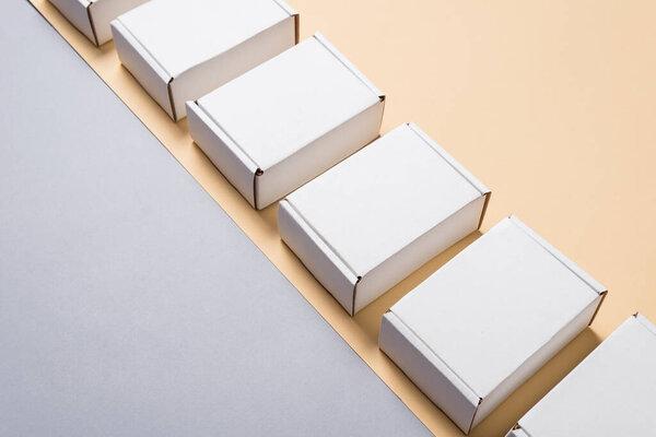 Set of white carton, cardboard flat mailer boxes on beige backgr