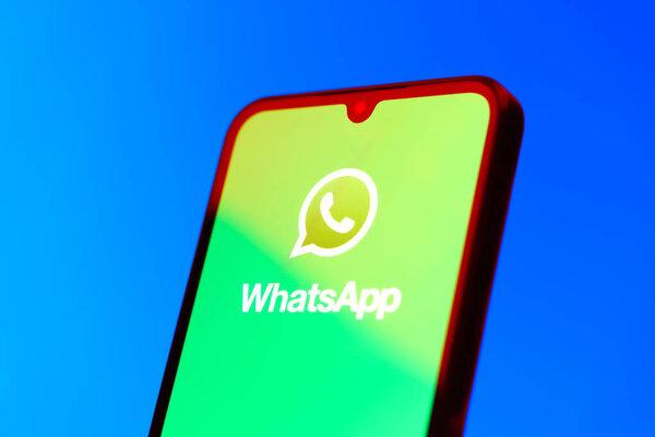 Prague, Czechia - 10 21 2024: Smartphone on surface showing WhatsApp logo.
