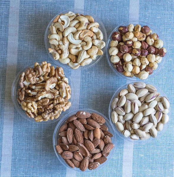 Healthy food. Nuts mix assortment on stone texture top view. Collection of different legumes for background image close up nuts, pistachios, almond, cashew nuts, peanut, walnut. image