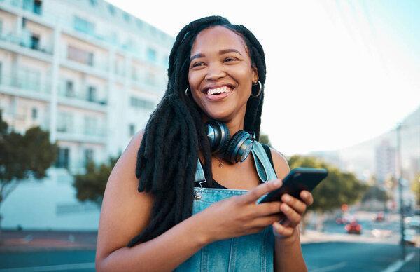 Student, street and happy girl with smartphone enjoying leisure break on weekend in Los Angeles. Black woman hipster with smile on commute with phone and headphones for music streaming in city