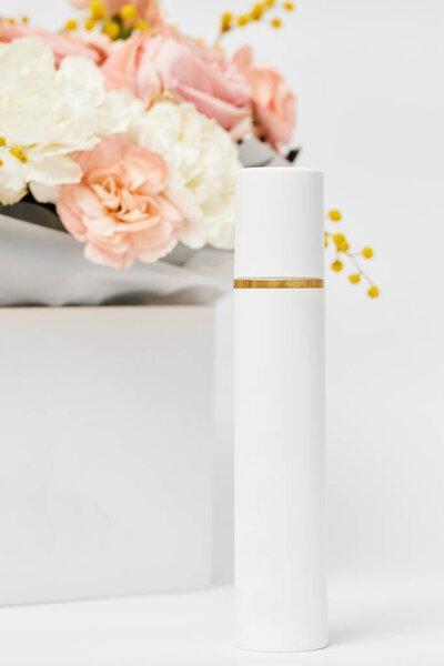 cosmetic beauty product bottle mockup with natural ingredient and spring flower. natural concept