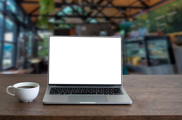 Front view of open laptop computer notebook with blank monitor white screen display on work table desk. Workspace office modern for job business online communication.