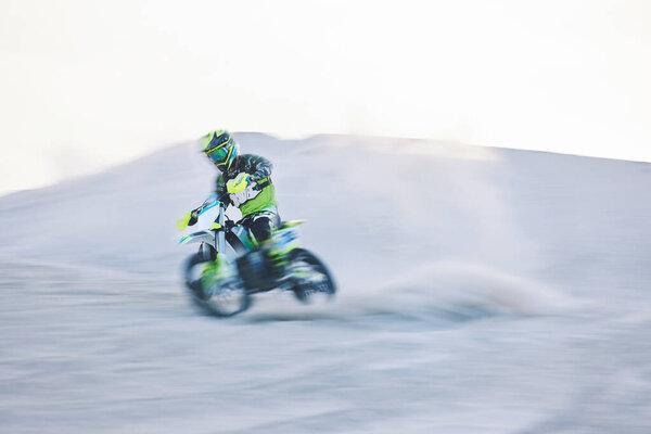 Blur, fast motorbike and man in desert for sports, action adventure or extreme travel on dirt on mockup space. Off road, sand and driver on motorcycle for speed in nature, competition race or freedom.