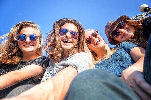 Group of happy smiling carefree young stylish girl female friends on city background, millennials concept, youth and students, travel and vacations tpgether