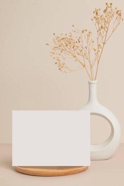greeting card front view and dry flower in vase ceramic on table