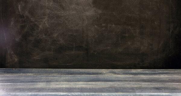 Back to school template. School classroom chalkboard, blank empty black board and blue wooden table