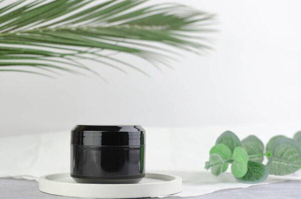 Moisturizer black packaging mockup. Closed black jar of moisturizer. The concept of natural cosmetic products