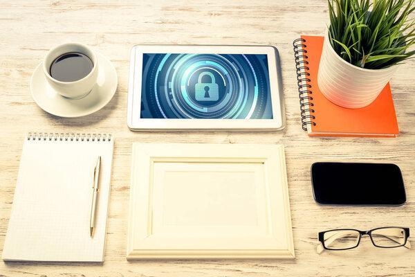 Business workplace with office stuff and tablet with padlock icons on screen