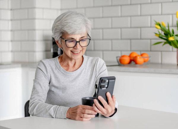 Charming Senora Is Having A Video Call In Kitchen