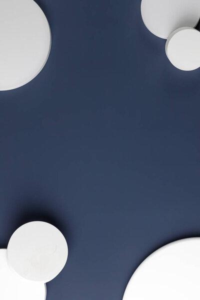 Podiums. White round podiums for presentation. Natural beauty pedestal on blue background. Copy space. Top view.