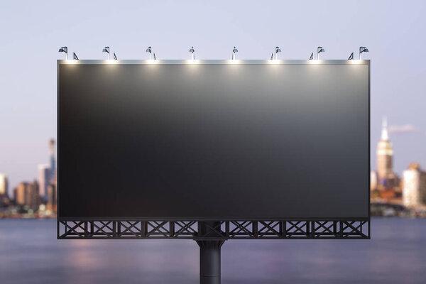 Blank black horizontal billboard on cityscape background at night, front view. Mockup, advertising concept