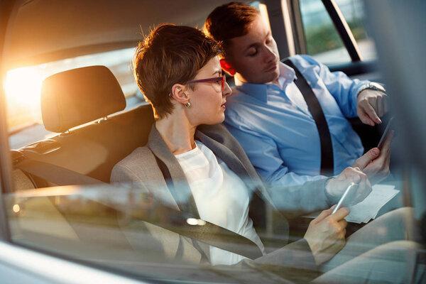 Conversation of business people in driving car