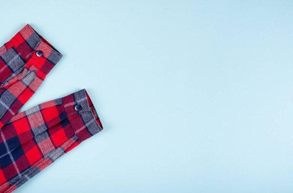 Textile, shirt composition on color background. Flat lay.