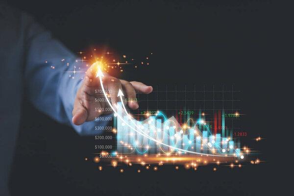 Businessman touching point virtual screen economic growth graph chart. Analysing trading of stock exchange, Financial and banking. Planning strategy of trading stock, and business to the future.