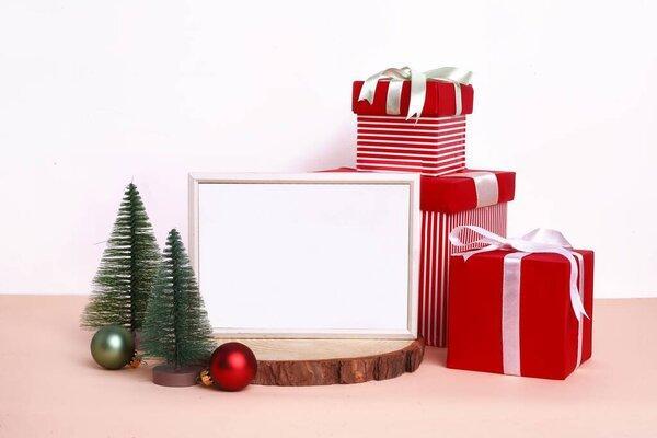 Cute Christmas setup with decorations and blank wooden frame in the middle