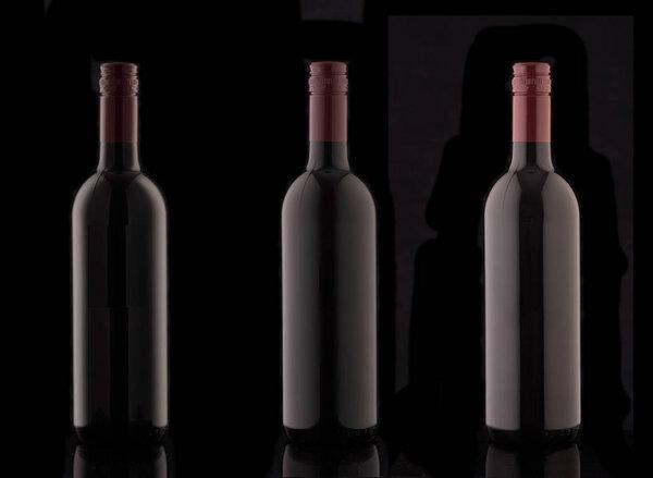 A bottle of red elite wine on a black background. Silhouette of a bottle of wine with a red stopper.