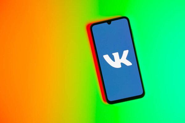 Prague, Czechia - 10 21 2024：Smartphone on surface showing vkontakte logo.