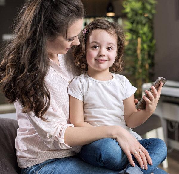 Happy mother with a daughter at home