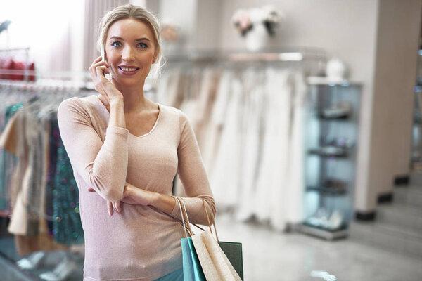 Waist up of young lady talking by mobile phone
