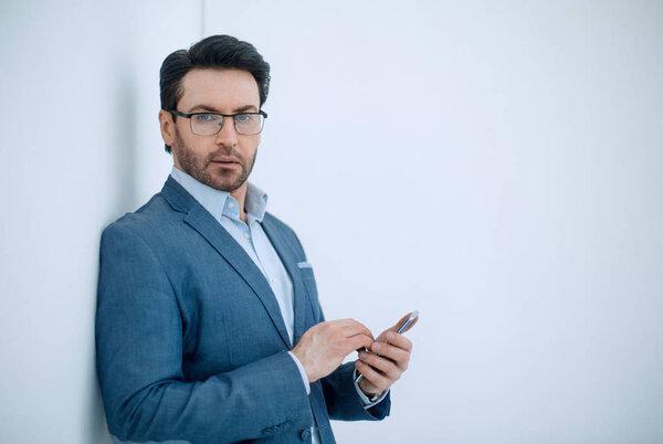 confident businessman typing SMS on your smartphone