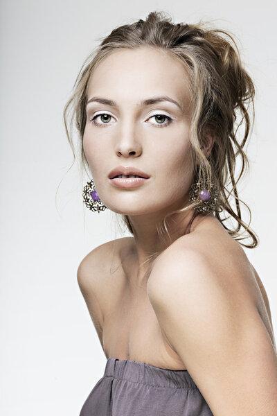 Beautiful face girl with perfect skin wearing jewelry