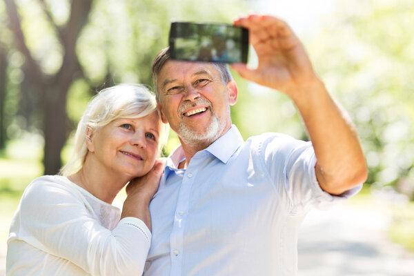Senior couple taking selfie