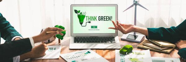 Business people in green corporate company planning eco-friendly and environmental conservative to reduce CO2 and implement net zero policy in meeting room with eco idea on laptop screen. Trailblazing