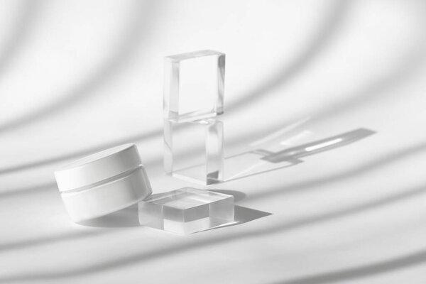 Cream lotion pot cosmetics showcase presentation mockup on white. White creme cosmetic jar on acrylic geometric pedestal podium block, beauty product packaging with shadows