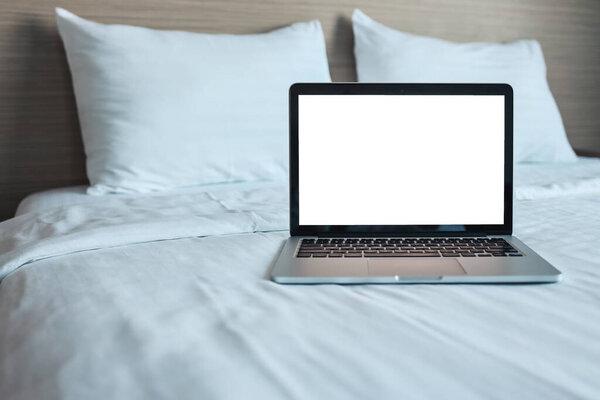 Mock up Blank screen laptop on the bed for advertising and text.