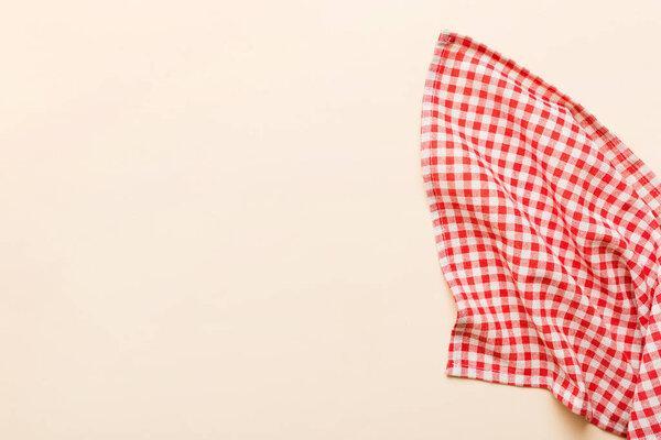 top view with red empty kitchen napkin isolated on table background. Folded cloth for mockup with copy space, Flat lay. Minimal style.