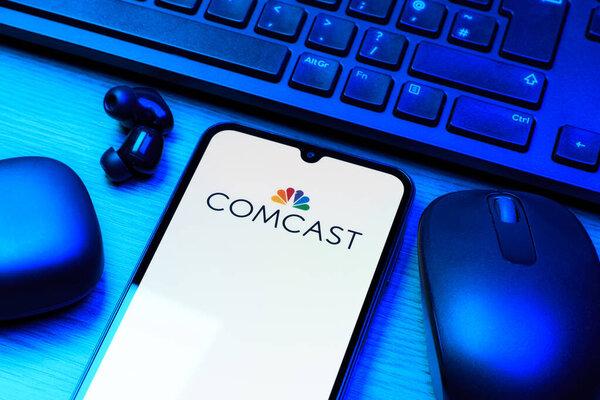 Prague, Czechia - 10 21 2024: Smartphone on surface showing Comcast logo