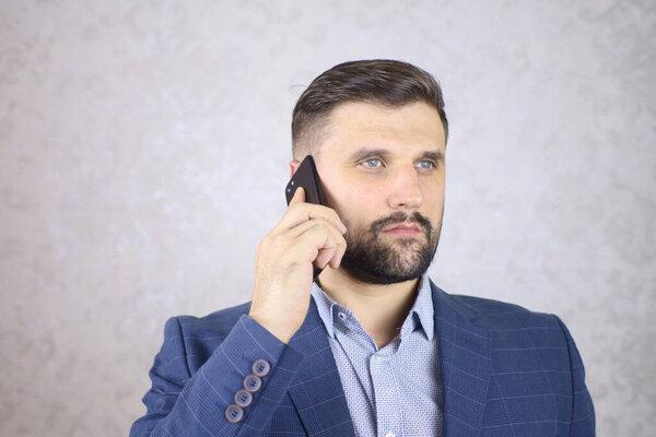 a businessman with a phone in his hand is negotiating