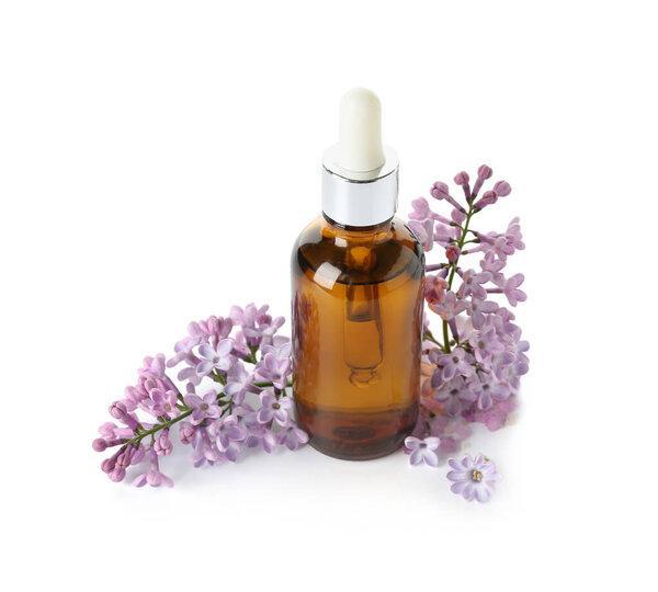 Bottle of cosmetic oil with beautiful lilac flowers on white background