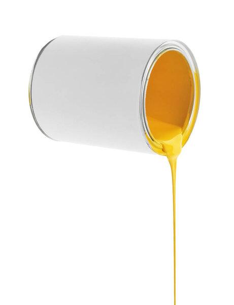 Yellow paint flowing down from can on white background