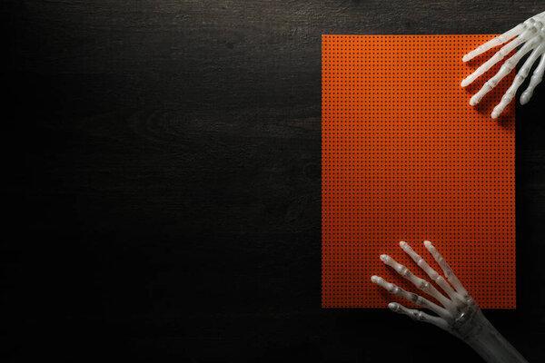 Hands and sheet of paper on wooden background, space for text