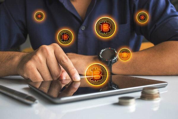 bitcoins fall in laptop. businessmen make money on laptops with soft focus and backlighting. cryptocurrency concept