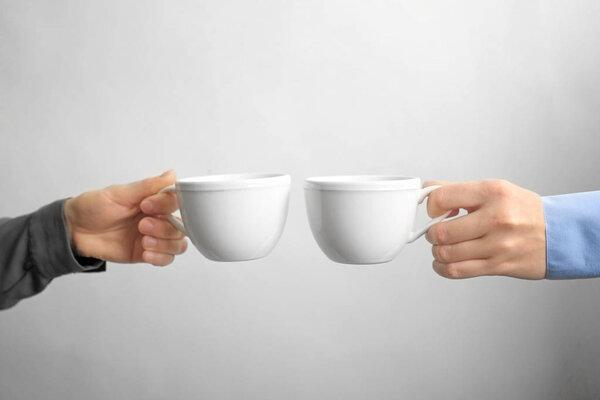 white cups in hands