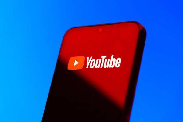 Prague, Czechia - 10 21 2024: Smartphone on surface showing Youtube logo.