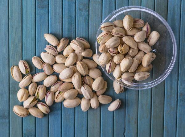 Healthy food  for background image close up pistachios nuts. Texture on top view Nuts pistachio on the cup plate