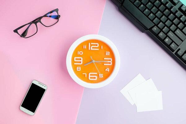 Workspace desk with ,business cards and clock .Lifestyle modern colorful background Top view