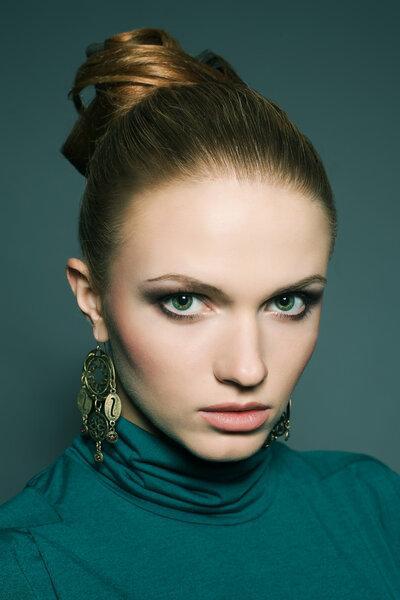 A beautiful young blond wearing green (blue) dress over green (b