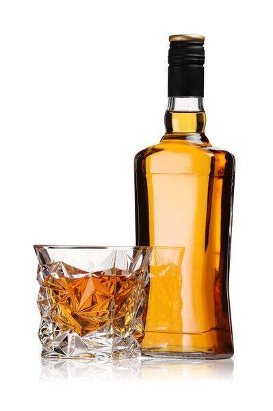 Glass and bottle of whiskey isolated on white