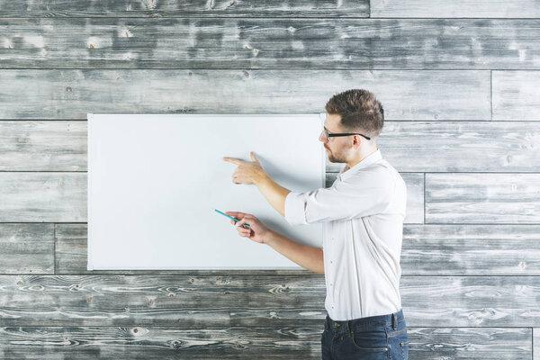 Attractive man pointing at whiteboard 