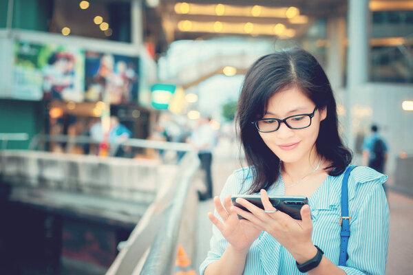 Young woman using smartphone in City