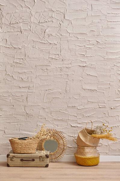 Wicker home object, bag, vase, mirror, baggage, plant in front of the concrete stone wall background, cotton dry plant, hanging, chair, blanket, decoration interior house room.