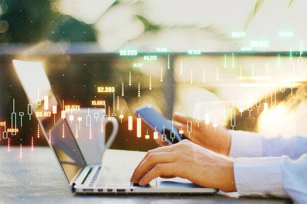 Forex exchange concept with glowing digital financial chart candlestick on businessman hands on laptop and smartphone background. Double exposure